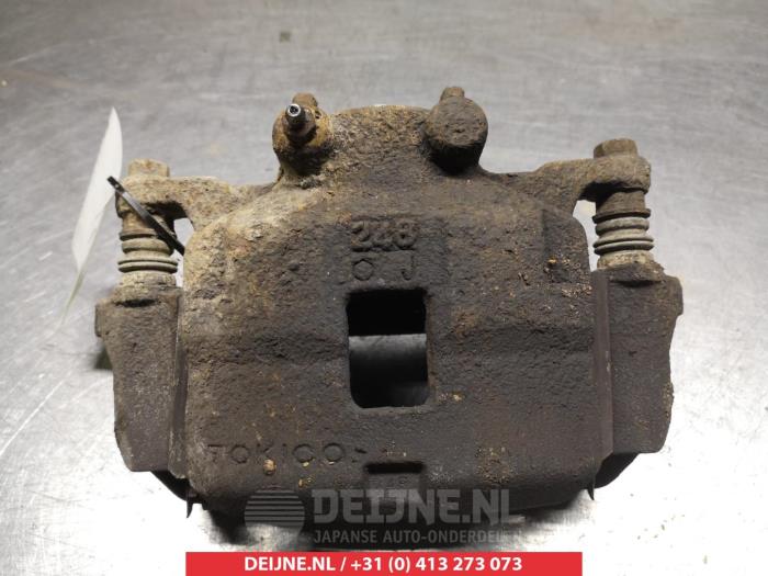 Mitsubishi L200 Front brake calliper, left O325268