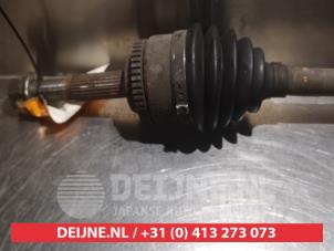 Nissan Almera Aandrijfas links-voor O317763 foto 2