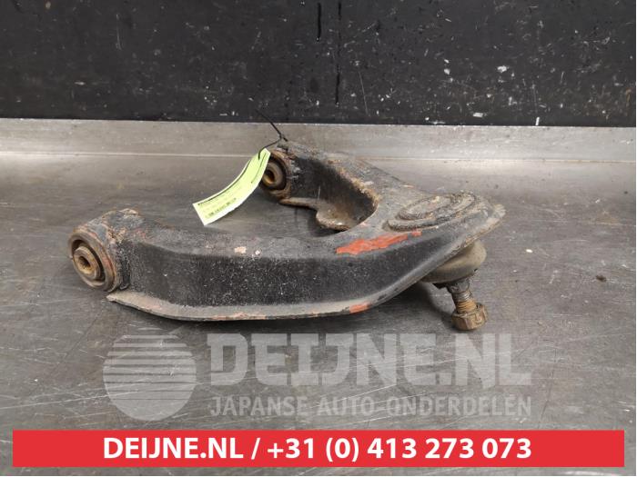 Nissan King Cab Draagarm boven rechts-voor O395329