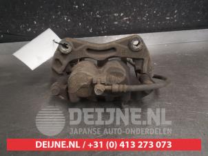 Nissan Qashqai+2 Bremszange links vorne O696470 foto 2