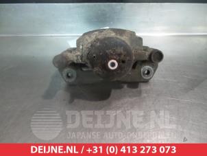Mazda 323 Front brake calliper, left O324570 photo 2