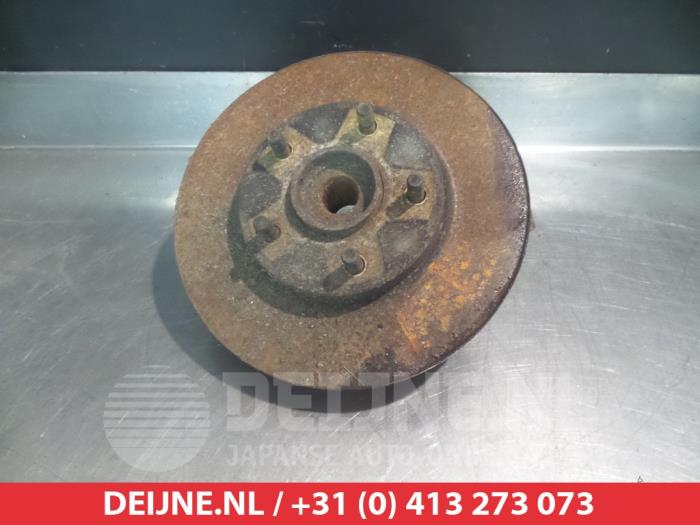 Nissan Almera Tino Fusee rechts-voor O323545