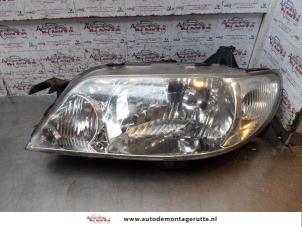 O154669 Gebruikte linker koplamp Mazda 323F