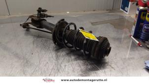 O163922 Gebruikte schokdemperpoot links-voor Opel Astra