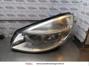 O164489 Gebruikte koplamp links Renault Scenic