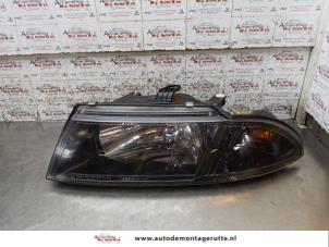 O168208 Gebruikte koplamp links Mitsubishi Carisma