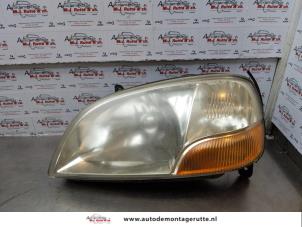 O173086 Gebruikte koplamp links Suzuki Ignis