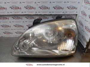 O179145 Gebruikte linker koplamp Kia Carens
