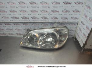 O190387 Gebruikte linker koplamp Kia Carnival