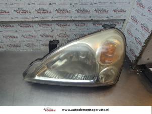 O194757 Gebruikte koplamp links Suzuki Liana
