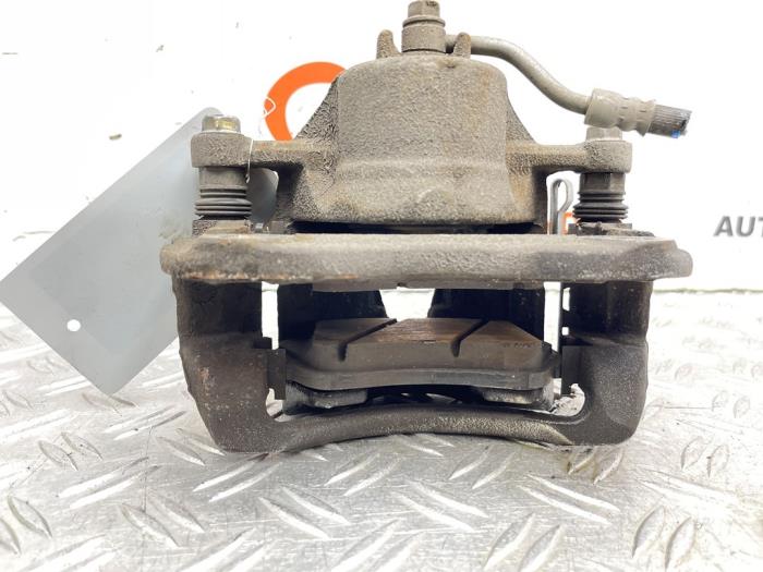 Remklauw (Tang) rechts-voor van een Kia Rio III (UB) 1.2 CVVT 16V 2016